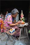 A woman painting artifacts for temples destroyed by the Khmer Rouge in Phnom Penh, Cambodia, Indochina, Southeast Asia, Asia