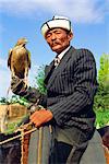 Man with his goshawk, Otoraigur near Balikchi, Kyrgyzstan, Central Asia