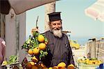 Priest shopping for oranges in Paphos Market, Cyprus, Europe