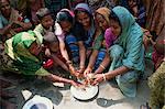 A group of Bangladeshi women and children washing hands as part of a health education scheme in Bangladesh, Asia