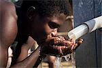 Teenage boy drinking from new UNICEF well, Vahun, Liberia, West Africa, Africa