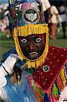Head and shoulders portrait of a person wearing mask headdress and brightly coloured costume, Gombey, island of Bermuda, Atlantic, Central America