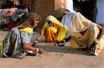 Women painting a mandana on the ground, village near Jodhpur, Rajasthan state, India, Asia