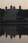 The Tower of London reflected in the calm water of the River Thames, London, England, United Kingdom, Europe