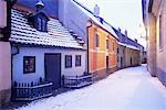 Snow covered 16th century cottages of Golden Lane (Zlata Ulicka) in winter twilight, Hradcany, Prague, Czech Republic, Europe