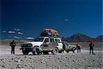 Landcruisers and tourists on jeep tour taking a break on Uyuni salt flat, Bolivia, South America