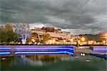 Water feature in front of the Potala Square lit up with neon blue lights in early evening, Lhasa, Tibet, China, Asia