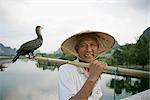 Fisherman with cormorant, Li River, Yangshuo, Guangxi Province, China, Asia