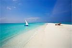 Dhoni and lounge chairs on tropical beach, Maldives, Indian Ocean, Asia