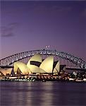 Opera House with Harbour Bridge in background, Sydney. Exterior at dusk.