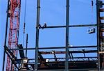 Construction workers building ,crane, UK