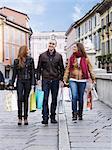 Young adults walking with shopping bags