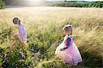 Girls dressed as princesses,  in a field