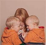 Mother holding twin sons