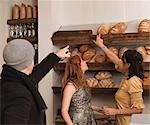 Man and woman pointing at bread on shelf