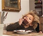 Young boy eating chocolate cake