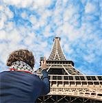 Man taking picture of Eiffel tower
