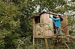 Girl mending treehouse