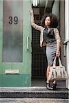 Young woman standing in doorway