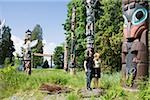 Couple looking at totem poles