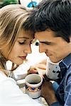 Couple touching foreheads over coffee