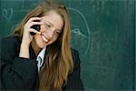 Young woman with strawberry blonde hair talking on cell phone