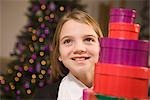 Girl with Stack of Christmas Gifts