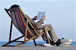Man Reading Book in Beach Chair