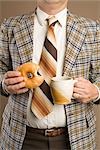 Retro Businessman Eating a Doughnut and Drinking a Cup of Coffee