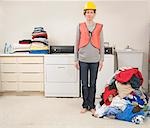 Woman Wearing Safety Vest and Hard Hat Doing the Laundry