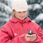 Close-up of Woman Using PDA Outdoors in Winter, Whistler, British Columbia, Canada