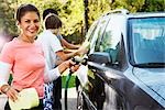 Woman and Teenage Sons Washing Car