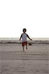 Boy Running on Beach