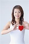 Young Japanese Woman Holding Heart