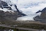 Road  with Snowcapped Mountains against Cloudy Sky