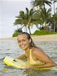 Portrait d'une adolescente sur une planche de surf