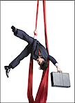 Businessman tangled in red drapes