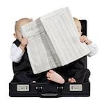 Twin boys sitting in a briefcase with newspaper