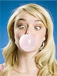 Girl blowing bubble and cross eyed