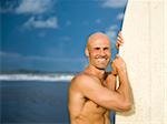 Man holding a surfboard.