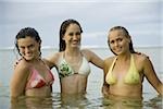 Portrait of three teenage girls in the sea