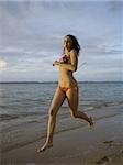 Portrait of a teenage girl running on the beach