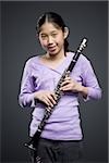 Portrait of a teenage girl holding a clarinet