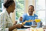 Senior man and a senior woman having breakfast