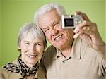 Close-up of an elderly couple taking a photograph of themselves