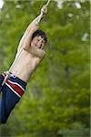 Portrait of a boy swinging on a rope