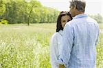 Close-up of a man and a woman in a field