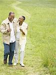 Senior man and a senior woman walking in a field