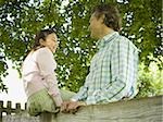 Low angle view of a man and his daughter smiling