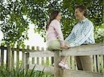 Low angle view of a man and his daughter smiling